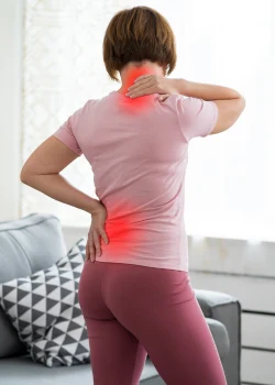 small image of a woman showing off back pain before back pain treatment available at morgain physical therapy in thompson north dakota